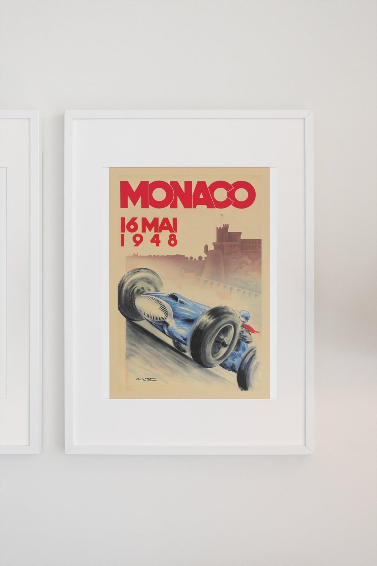 Monaco Grand Prix 1948 poster in a white frame on a light wall