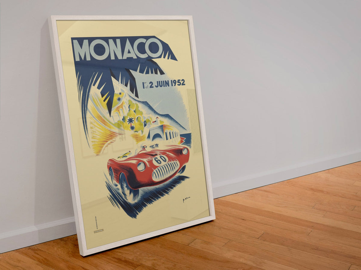 Monaco Grand Prix 1952 poster in a white frame leaning against a wall