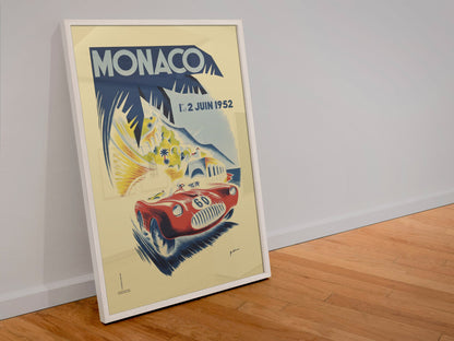Monaco Grand Prix 1952 poster in a white frame leaning against a wall