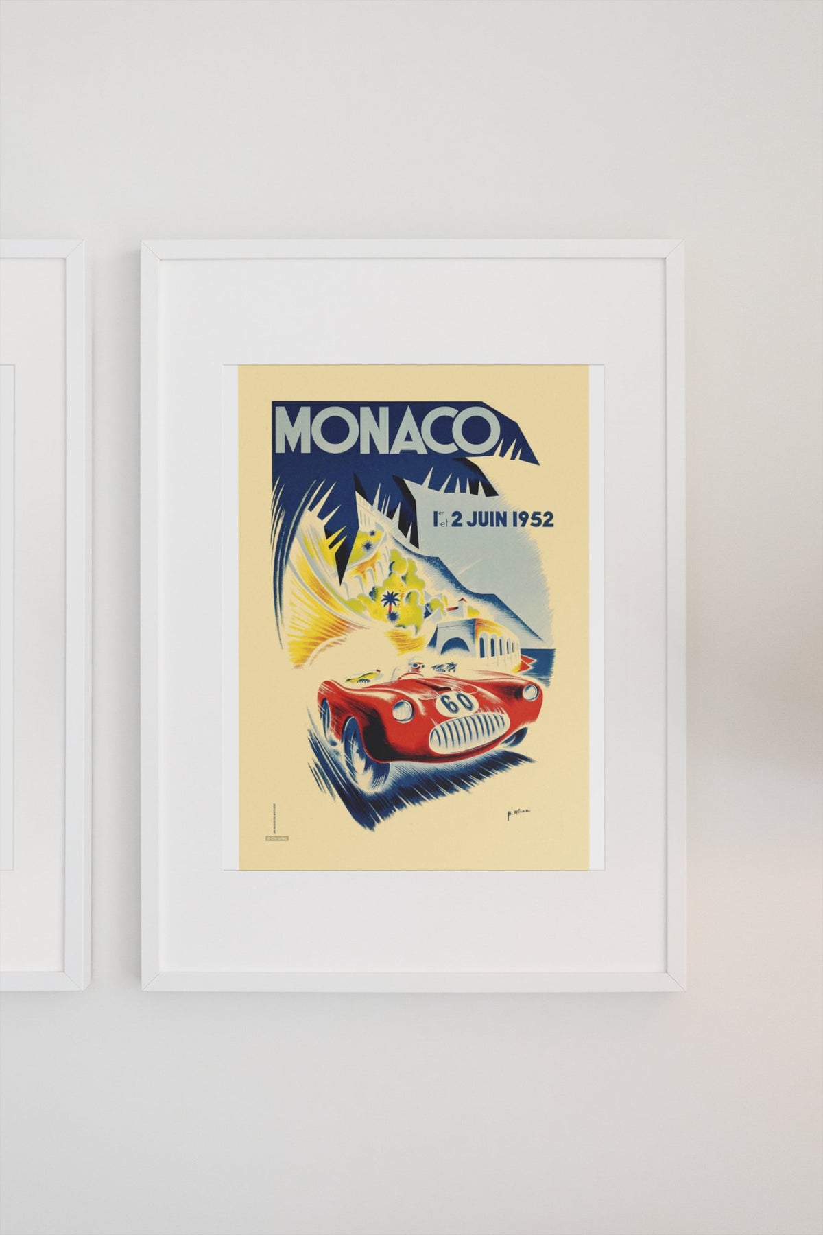 Monaco Grand Prix 1952 poster in a white frame on a light wall