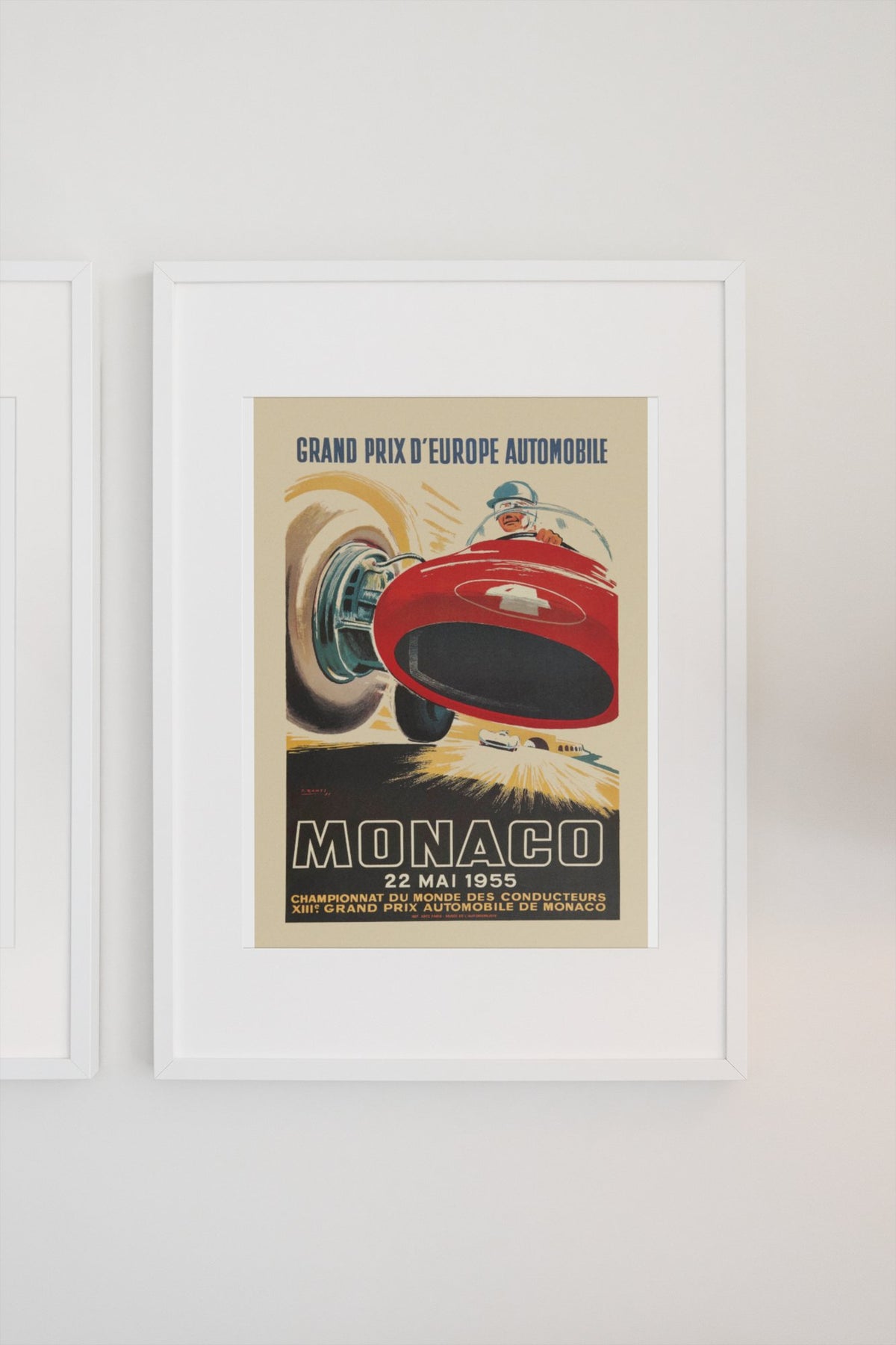 Monaco Grand Prix 1955 poster in a white frame on a light wall