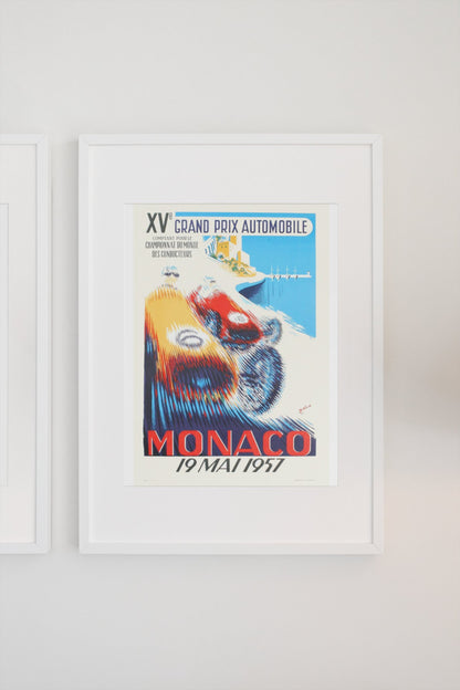 Monaco Grand Prix 1957 poster in a white frame on a light wall