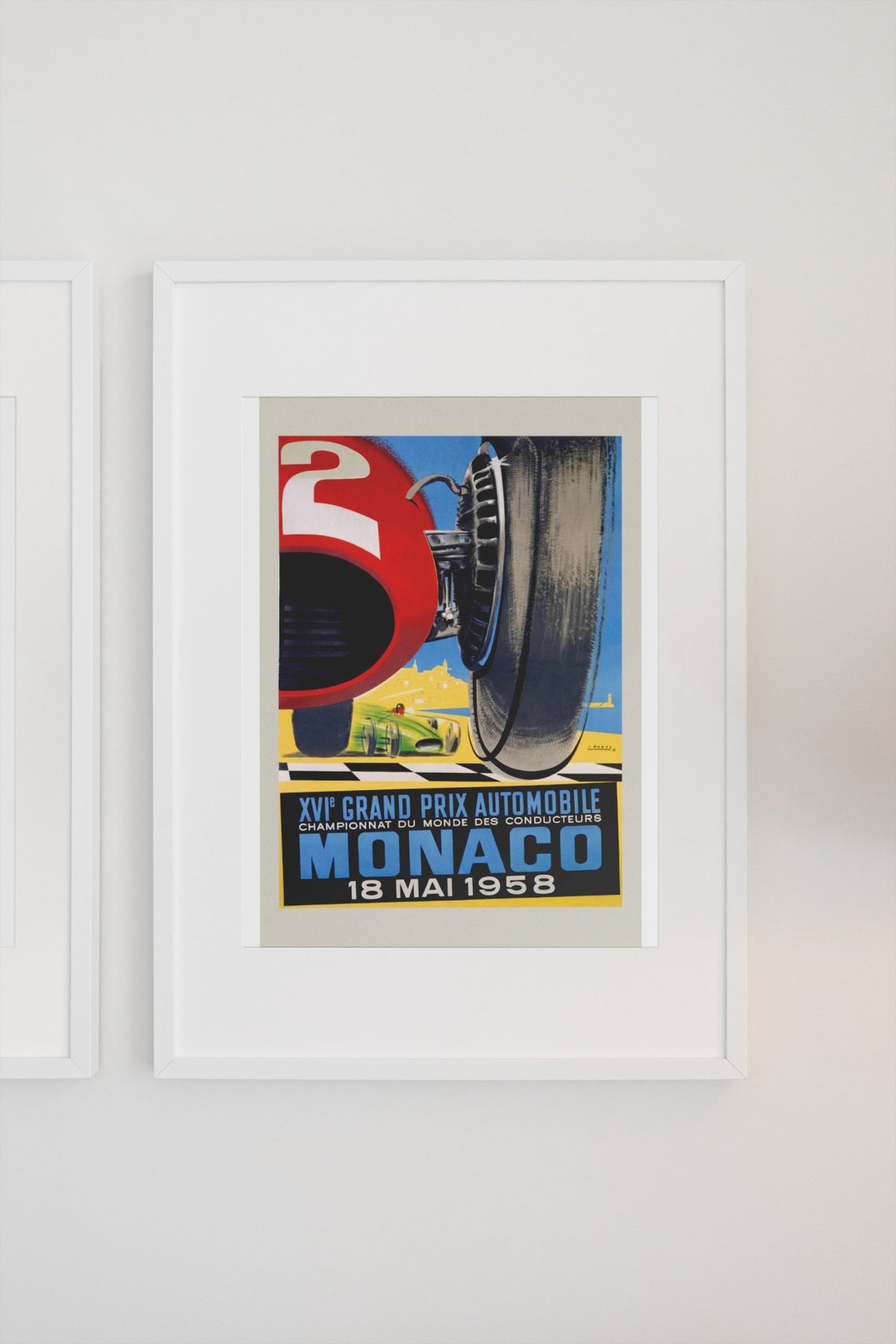 Monaco Grand Prix 1958 poster in a white frame on a light wall