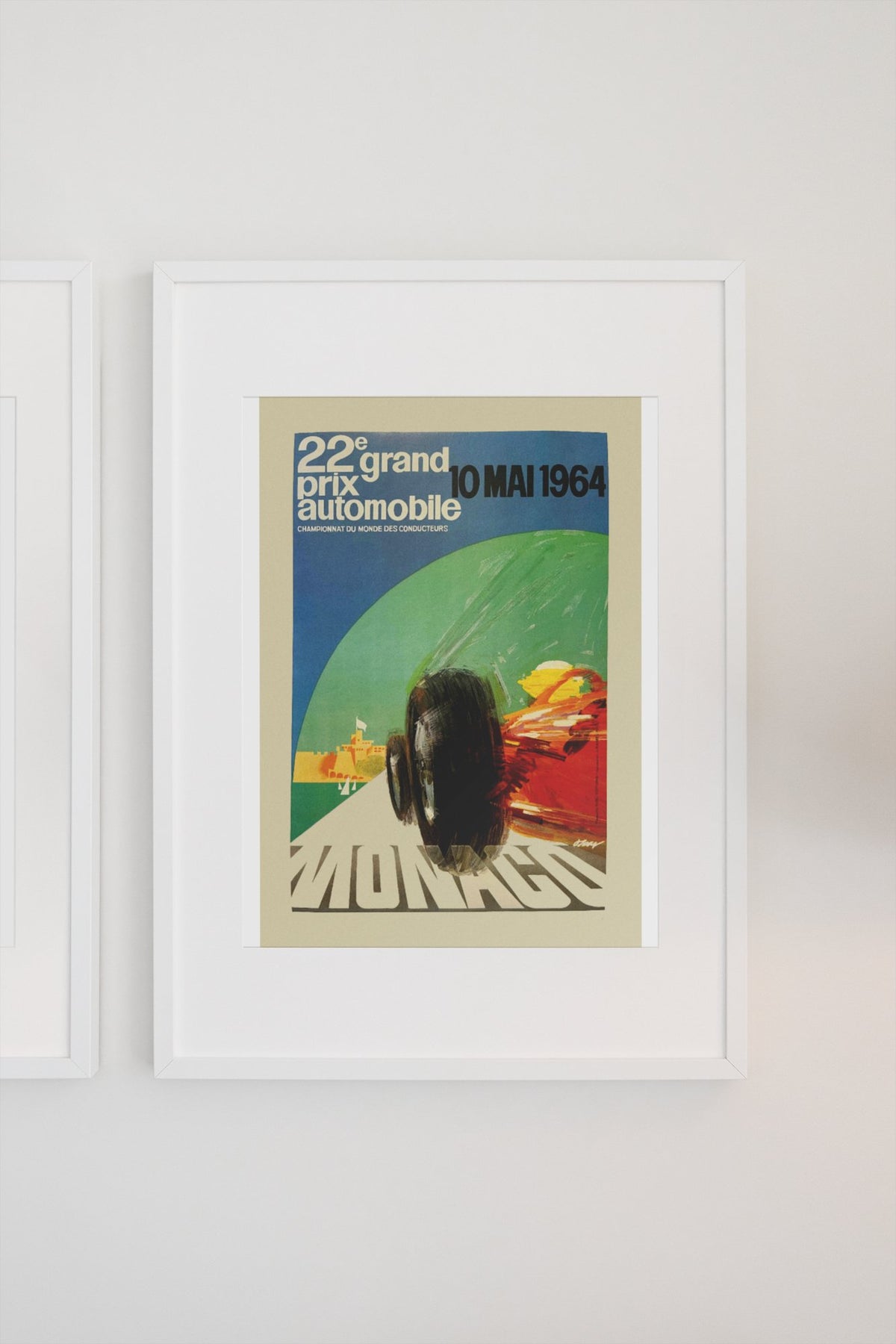 Monaco Grand Prix 1964 poster in a white frame on a light wall
