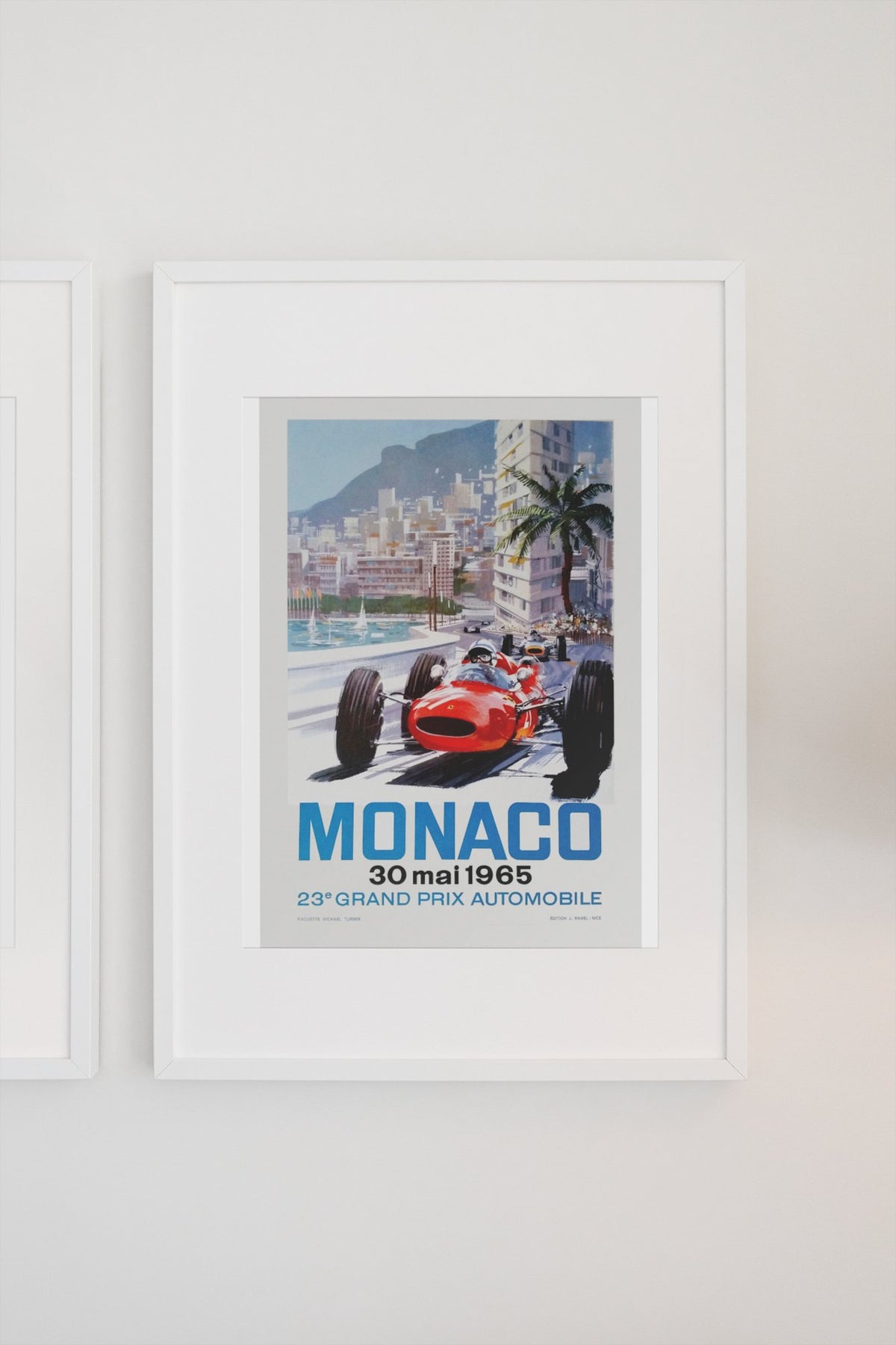 Monaco Grand Prix 1965 poster in a white frame on a light wall