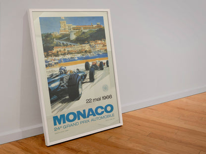 Monaco Grand Prix 1966 poster in a white frame leaning against a wall