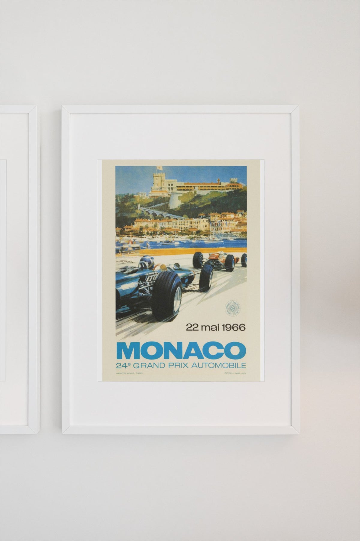 Monaco Grand Prix 1966 poster in a white frame on a light wall