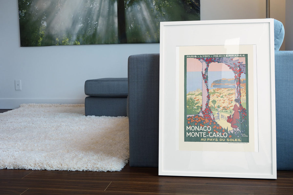 Monaco Monte Carlo poster leaning beside a blue sofa
