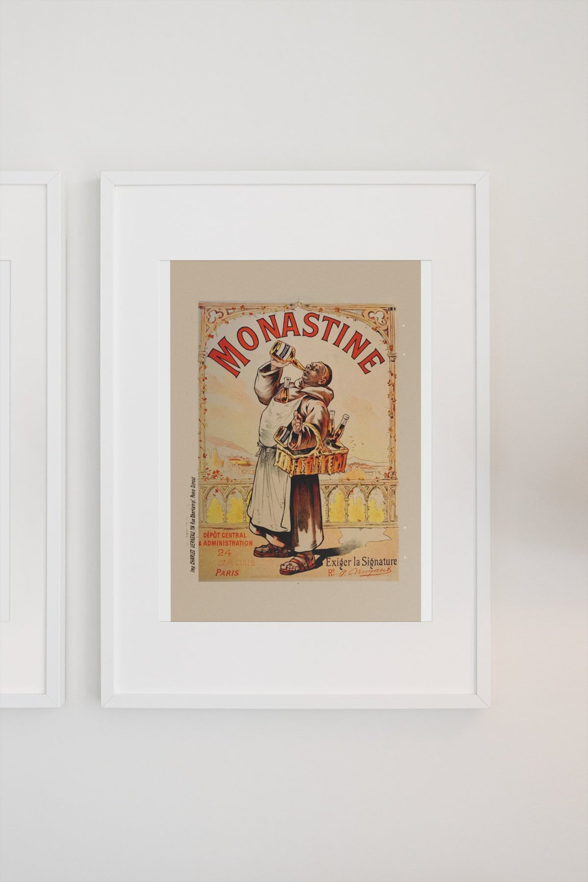 Monastine 1892 French liqueur poster in a white frame on a light wall