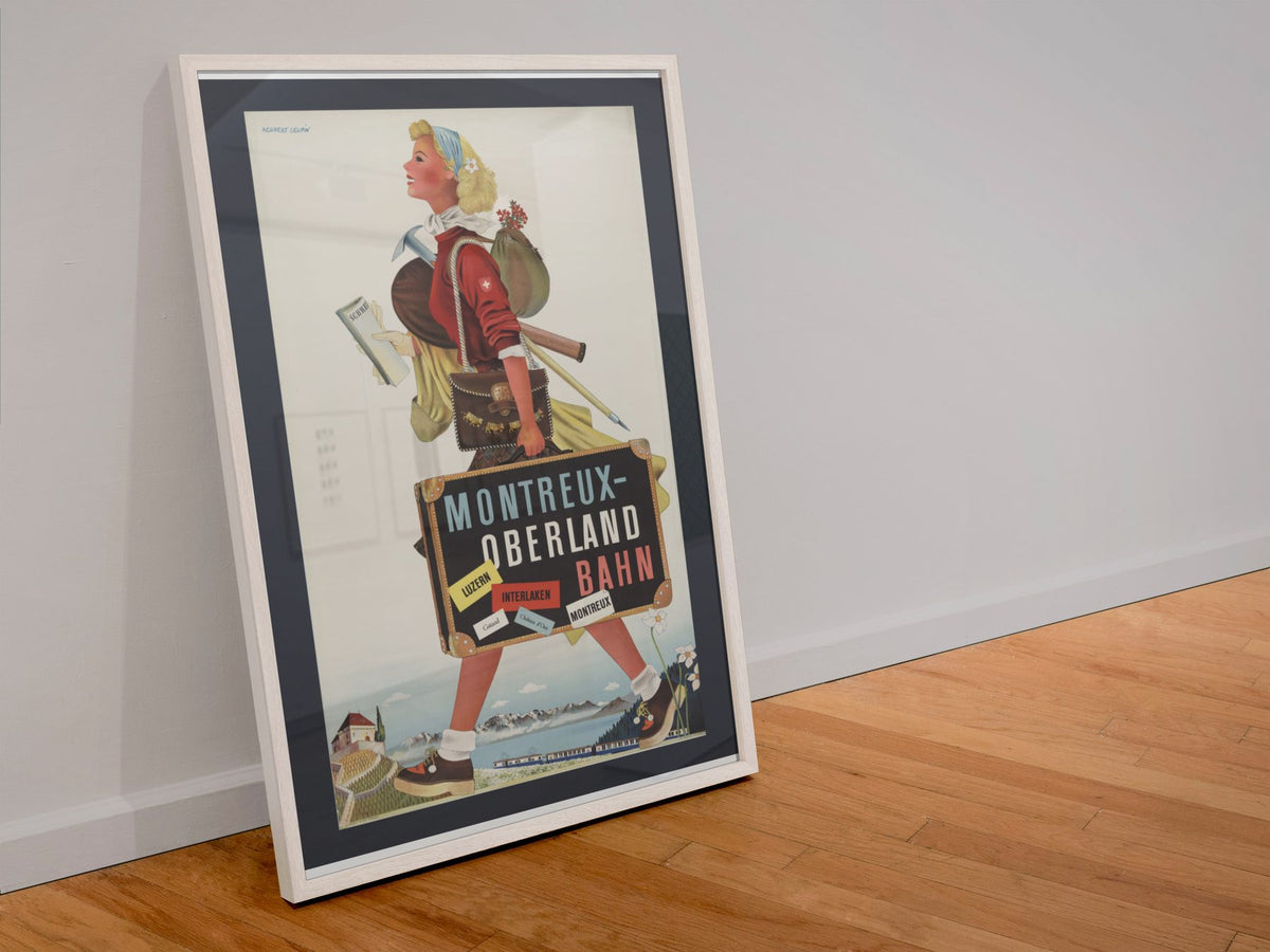Montreux Oberland Bahn poster in a white frame leaning against a wall