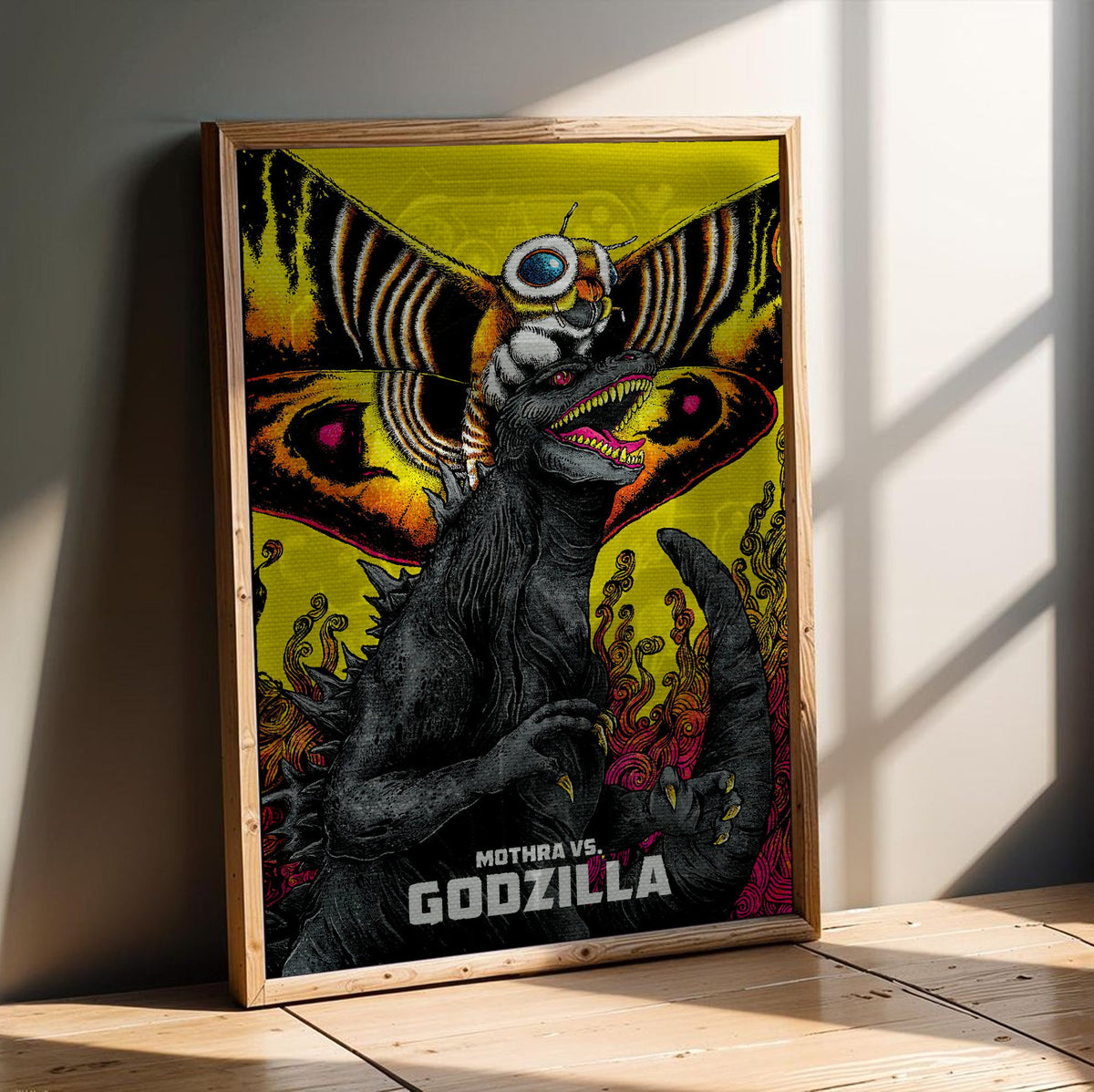 Mothra vs. Godzilla (1964) Movie Illustrated Art poster in an oak frame leaning on a wooden floor