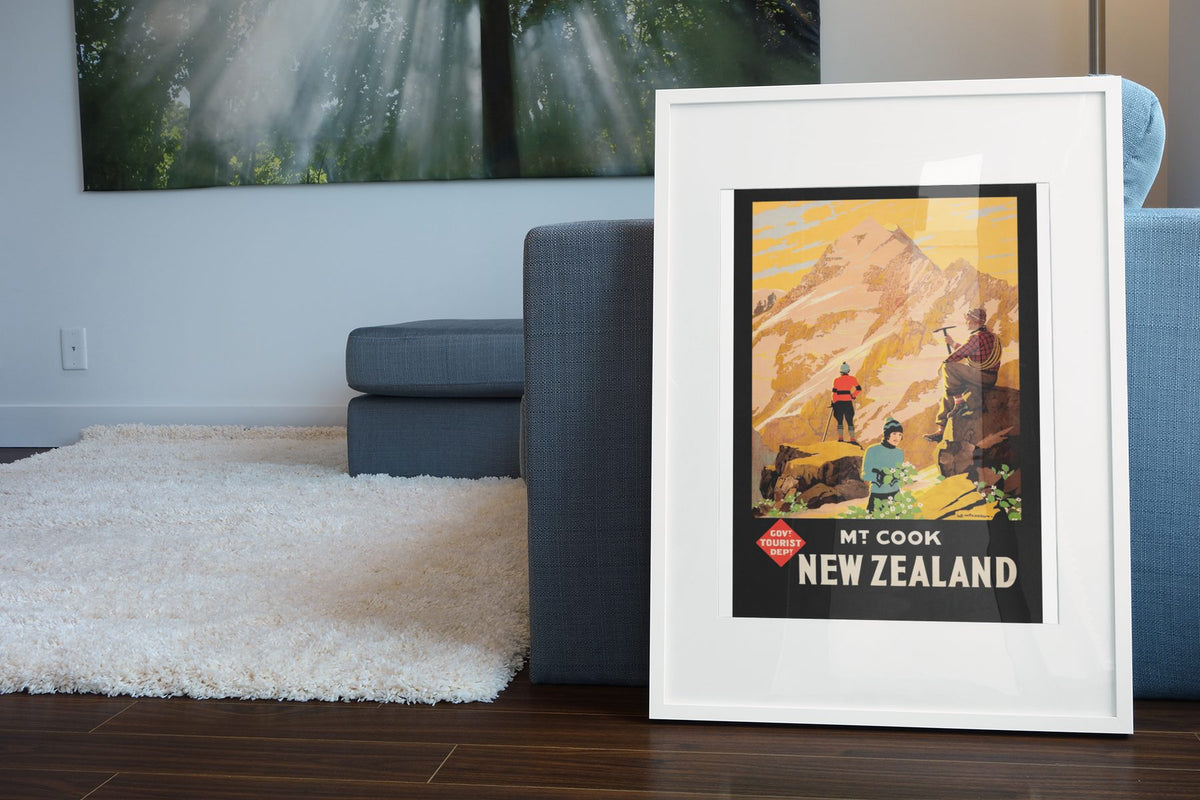 Mt Cook New Zealand poster leaning beside a blue sofa