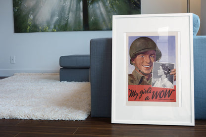 My Girls a WOW Woman Ordnance Worker poster leaning beside a blue sofa