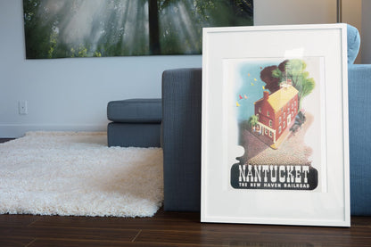 Nantucket New Haven Railroad poster leaning beside a blue sofa