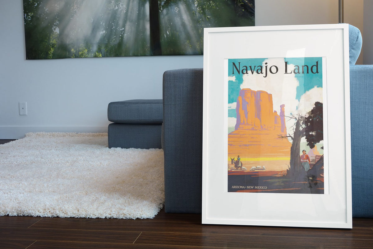Navajo Land Santa Fe poster leaning beside a blue sofa