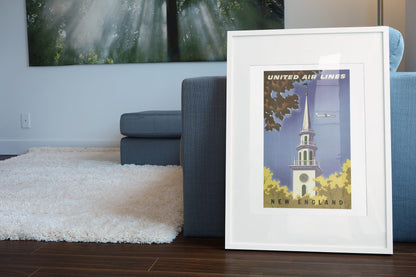 New England United Air Lines poster leaning beside a blue sofa