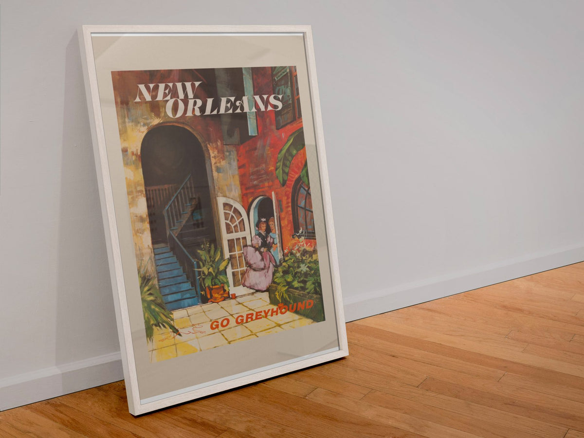 New Orleans Go Greyhound poster in a white frame leaning against a wall