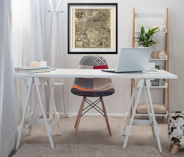 New World 1562 Gutierrez Map framed above a white desk in a home office