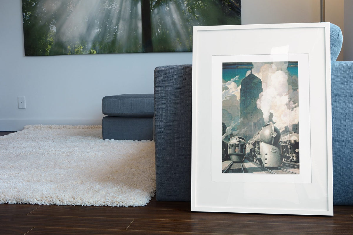 New York Central System Streamliner poster leaning beside a blue sofa