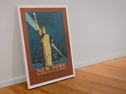 New York Wonder City Travel by Train poster in a white frame leaning against a wall