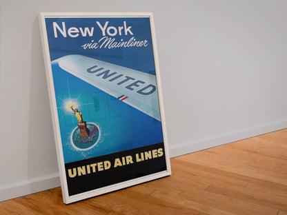 New York via Mainliner poster in a white frame leaning against a wall