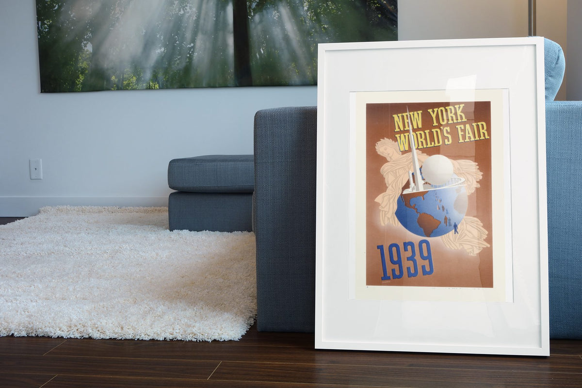 New York Worlds Fair 1939 Globe poster leaning beside a blue sofa