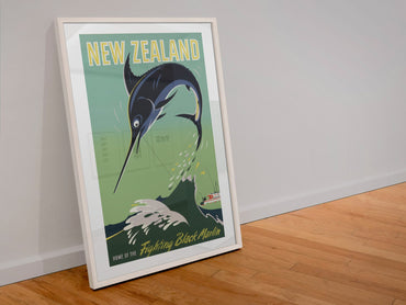New Zealand Black Marlin poster in a white frame leaning against a wall
