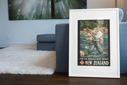 New Zealand Fly Fishing poster leaning beside a blue sofa