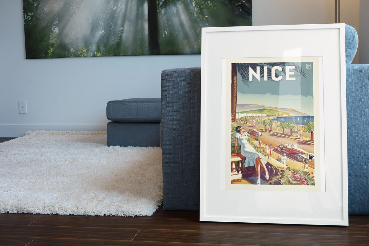 Nice French Riviera poster leaning beside a blue sofa