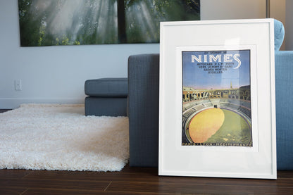 Nimes Roman Amphitheater poster leaning beside a blue sofa