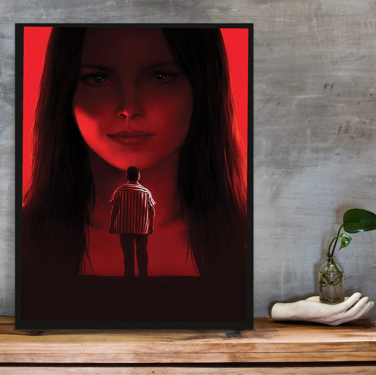 Obsession (2026) Movie Key Art poster in a black frame on a wooden shelf against concrete