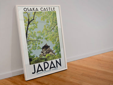 Osaka Castle Japan poster in a white frame leaning against a wall