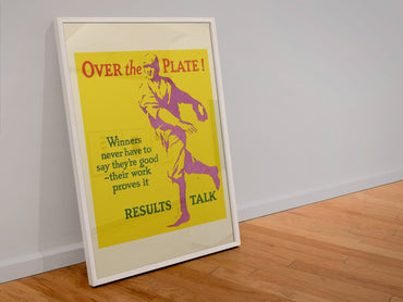 Over the Plate poster in a white frame leaning against a wall