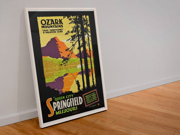 Ozark Mountains Lake Taneycomo poster in a white frame leaning against a wall