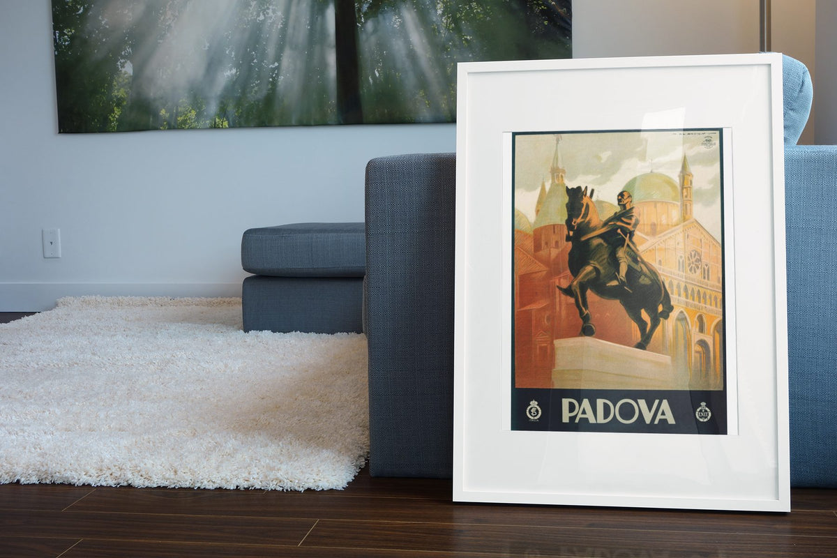 Padova Gattamelata Monument poster leaning beside a blue sofa