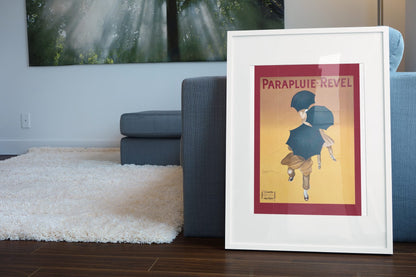 Parapluie Revel Cappiello poster leaning beside a blue sofa
