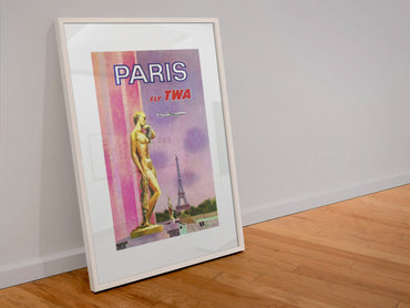 Paris Fly TWA 1969 poster in a white frame leaning against a wall