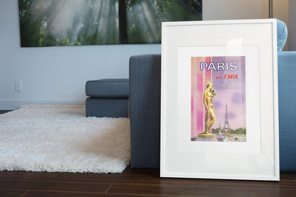 Paris Fly TWA 1969 poster leaning beside a blue sofa
