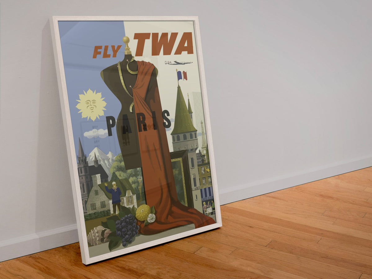 Paris Fly TWA 1950s poster in a white frame leaning against a wall
