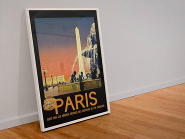 Paris Place de la Concorde poster in a white frame leaning against a wall