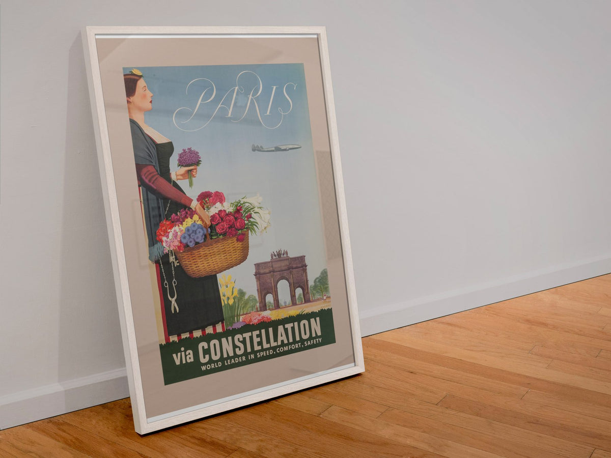 Paris via Constellation poster in a white frame leaning against a wall
