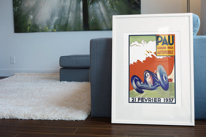 Pau Grand Prix 1937 poster in a white frame leaning beside a blue sofa