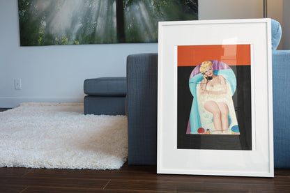 Peek-a-Boo poster leaning beside a blue sofa