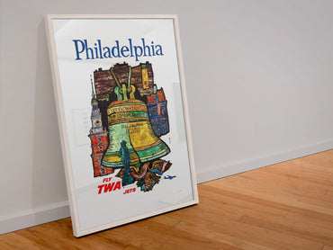 Philadelphia Fly TWA poster in a white frame leaning against a wall