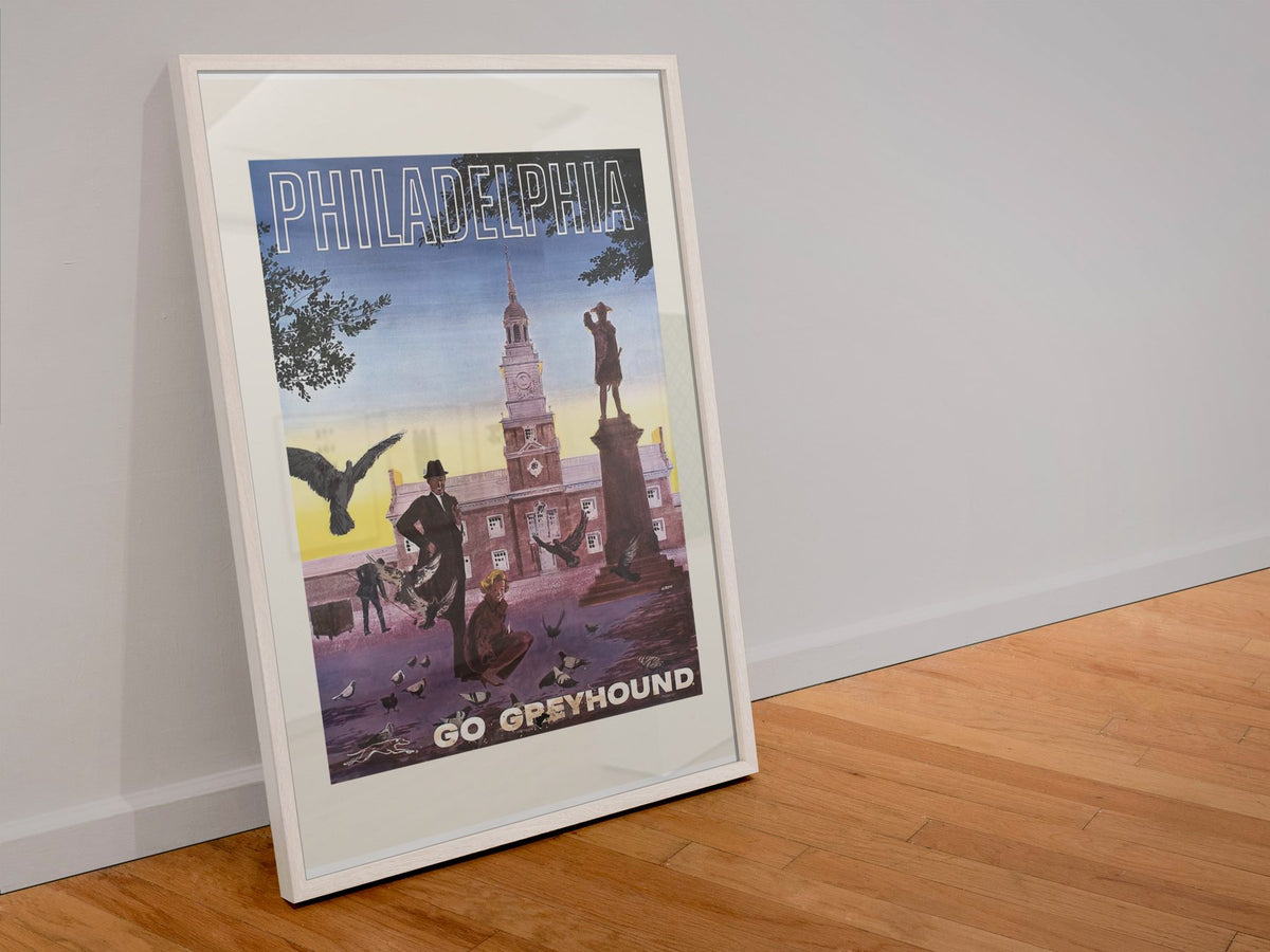 Philadelphia Go Greyhound poster in a white frame leaning against a wall
