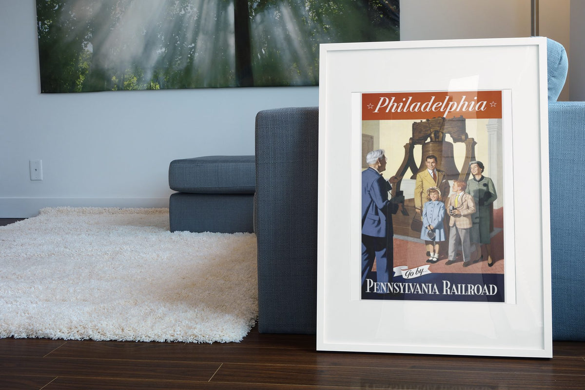 Philadelphia Pennsylvania Railroad poster leaning beside a blue sofa