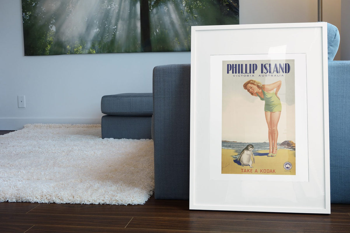 Phillip Island — Take a Kodak poster leaning beside a blue sofa