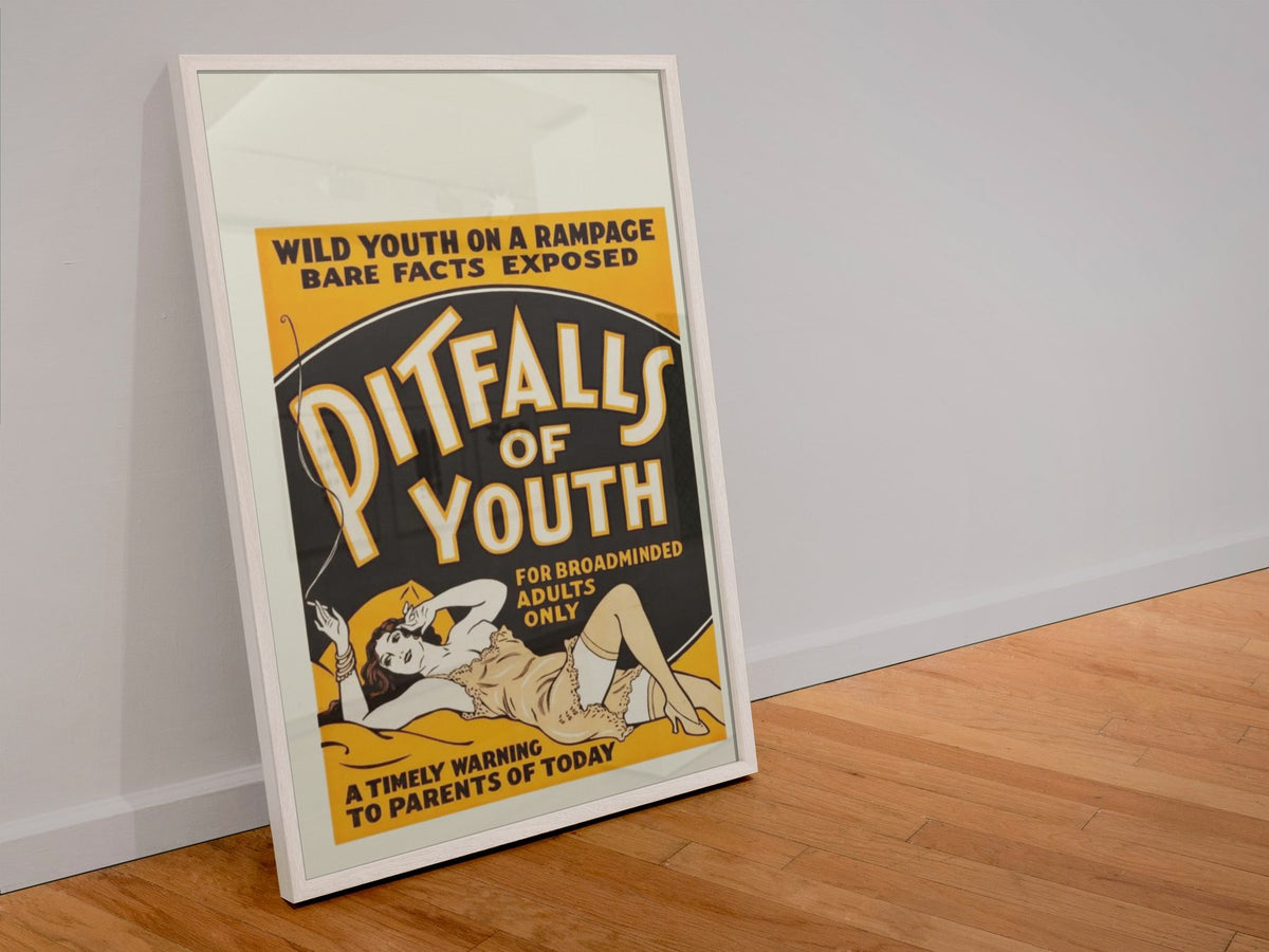 Pitfalls of Youth poster in a white frame leaning against a wall