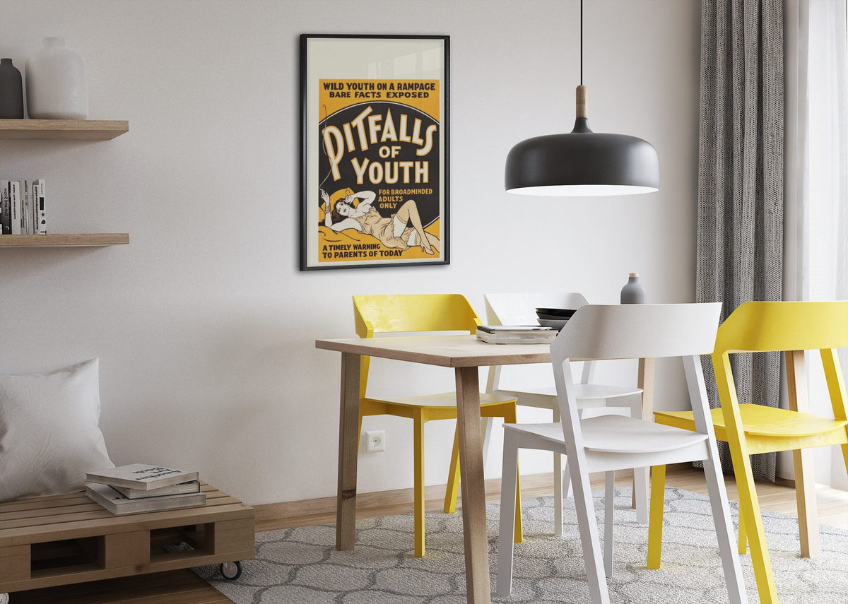 Pitfalls of Youth poster framed above a dining table
