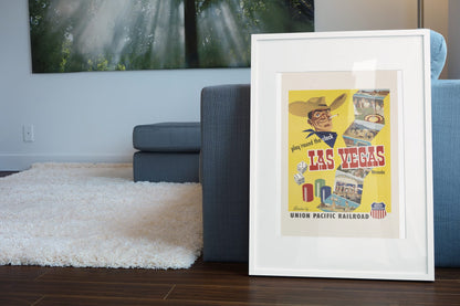 Play Round the Clock Las Vegas poster leaning beside a blue sofa